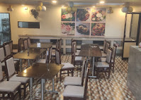 Dining hall at Sri Garuda Vihar with tables and warm lighting