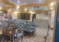Spacious dining area with patterned chairs at Sri Garuda Vihar